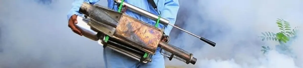 Fumigation technician using a fogger for deep pest treatment in Detroit, MI